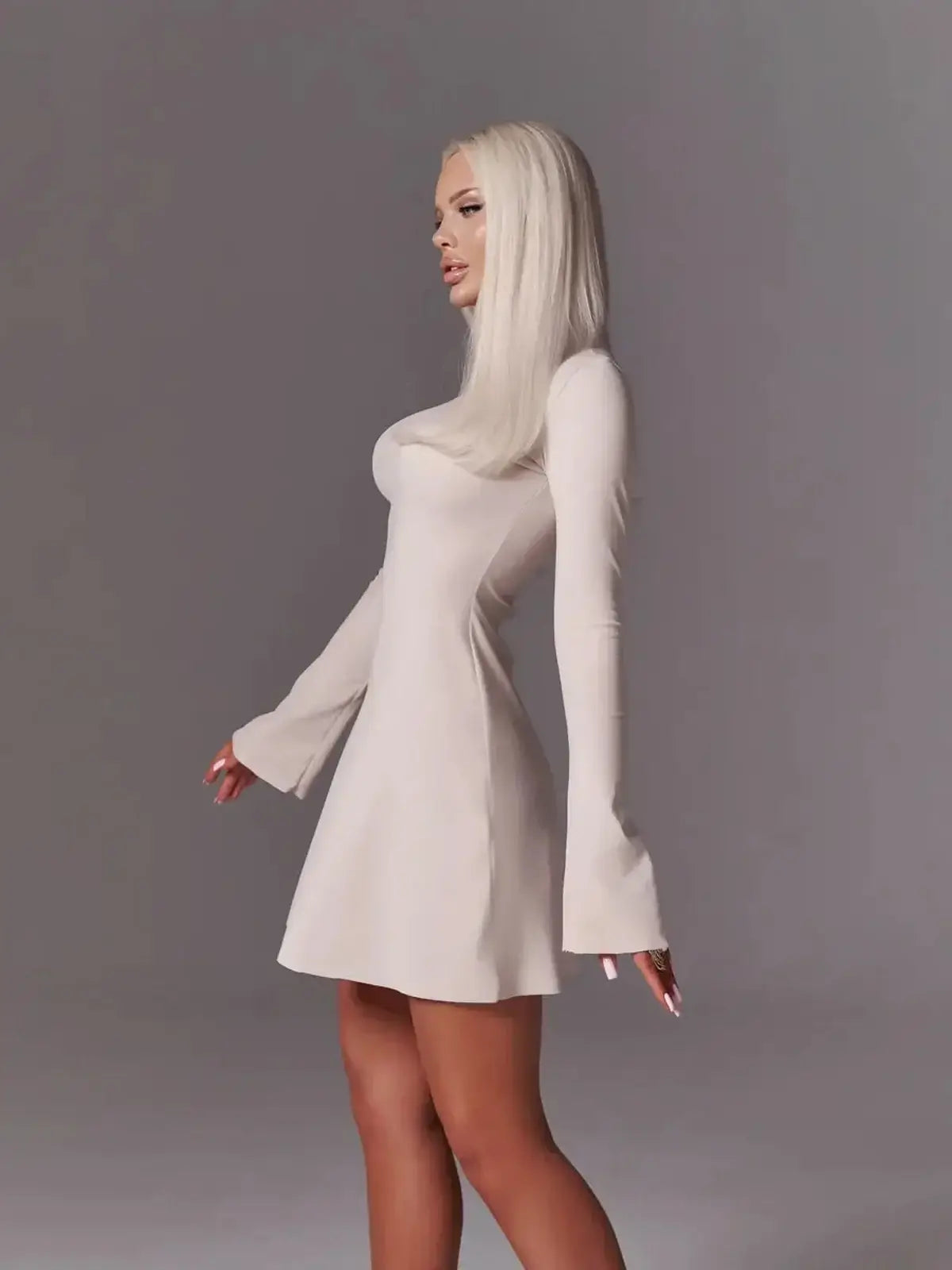Ivory flare mini dress with bell sleeves, featuring a sleek fit and modern minimalism for wedding or cocktail events.