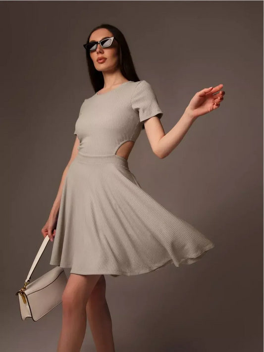 Model wearing the Breezy Hour mini dress with cutout detail, perfect for summer weddings and casual outings.