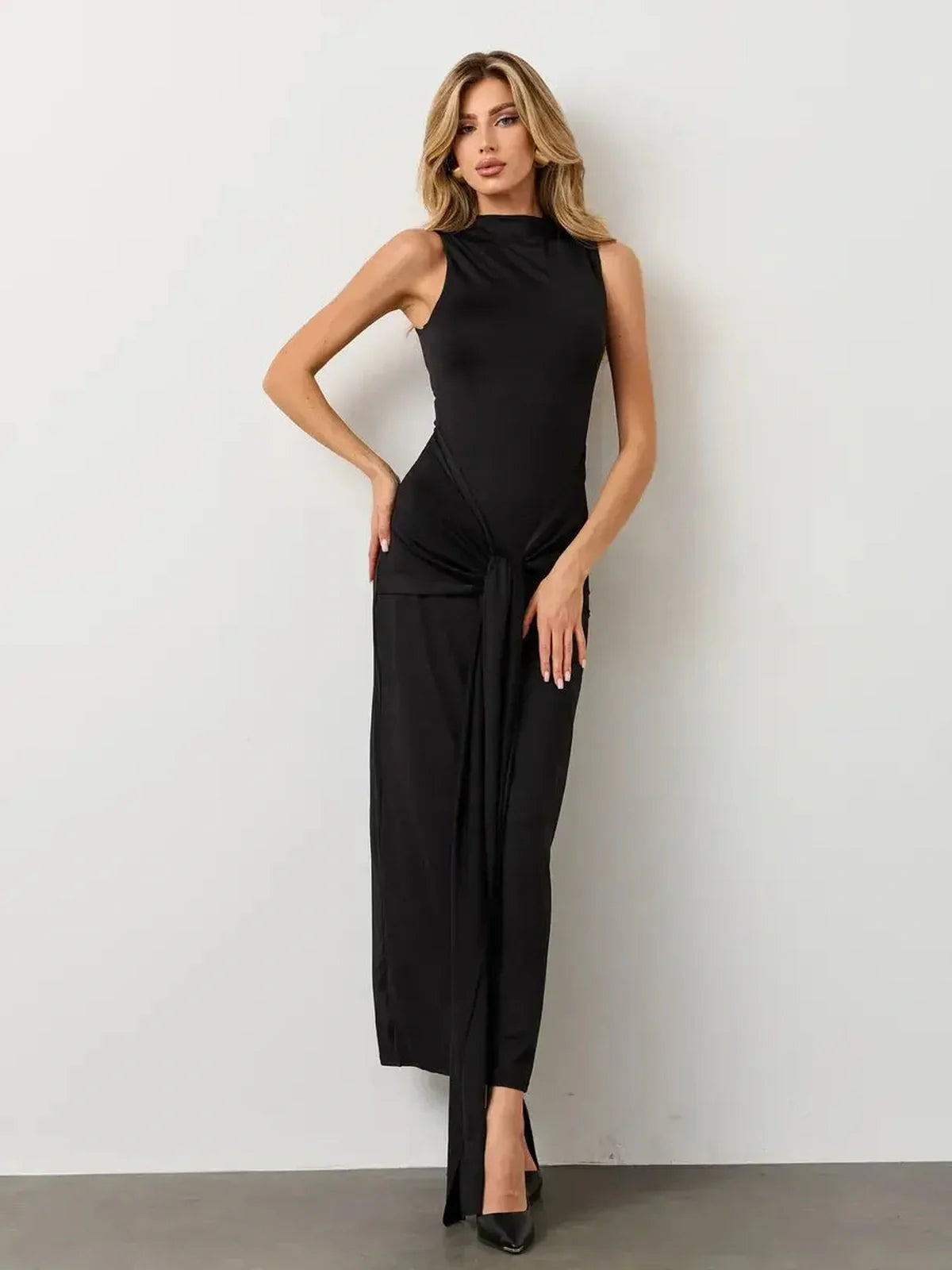 Elegant sleeveless black Obsidian Drape Maxi Dress with knotted draping, perfect for formal or evening events.