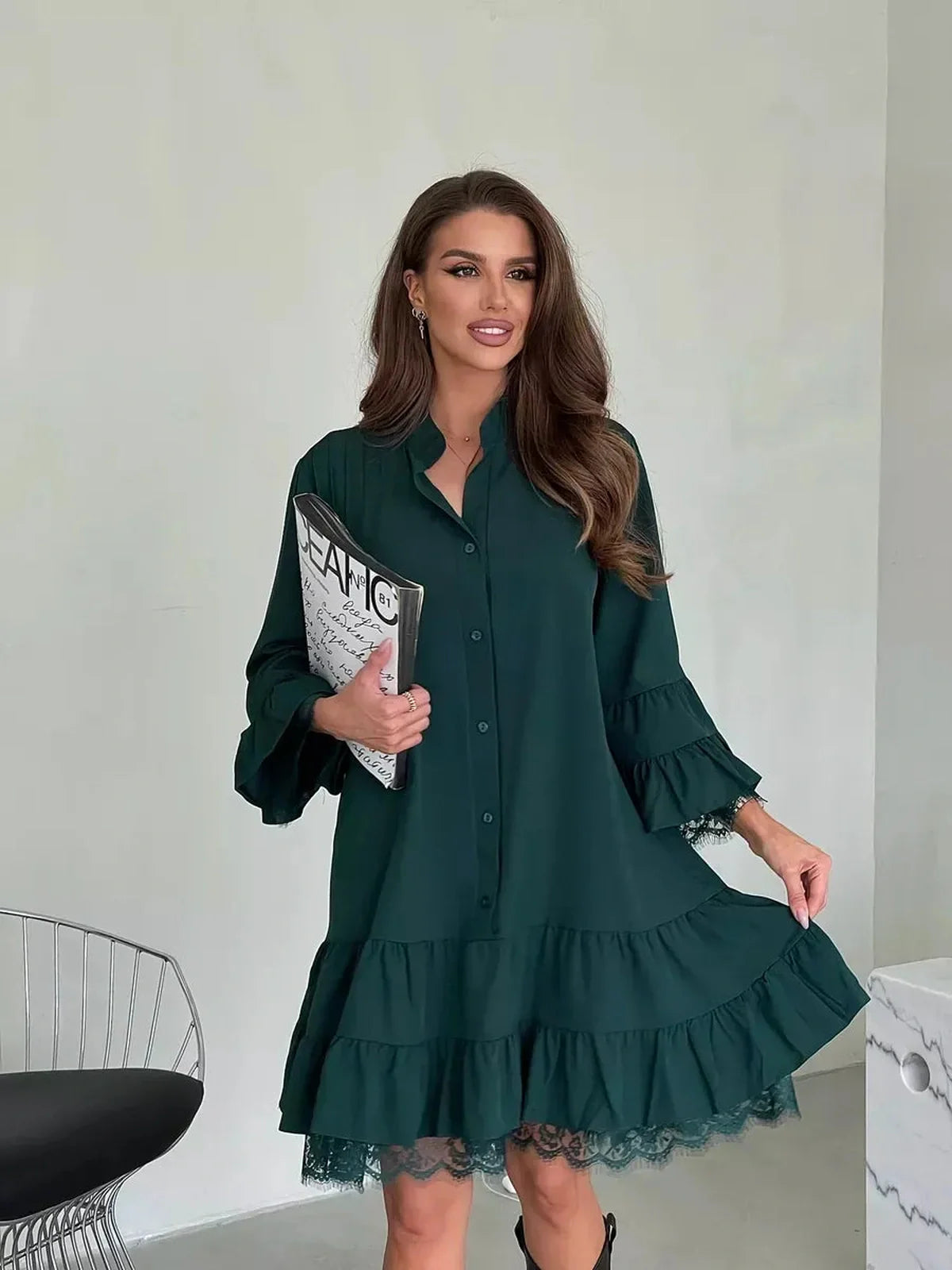 Elegant woman in emerald Lace Aura Mini Dress with tiered silhouette and lace trim, perfect for wedding guest or summer events.