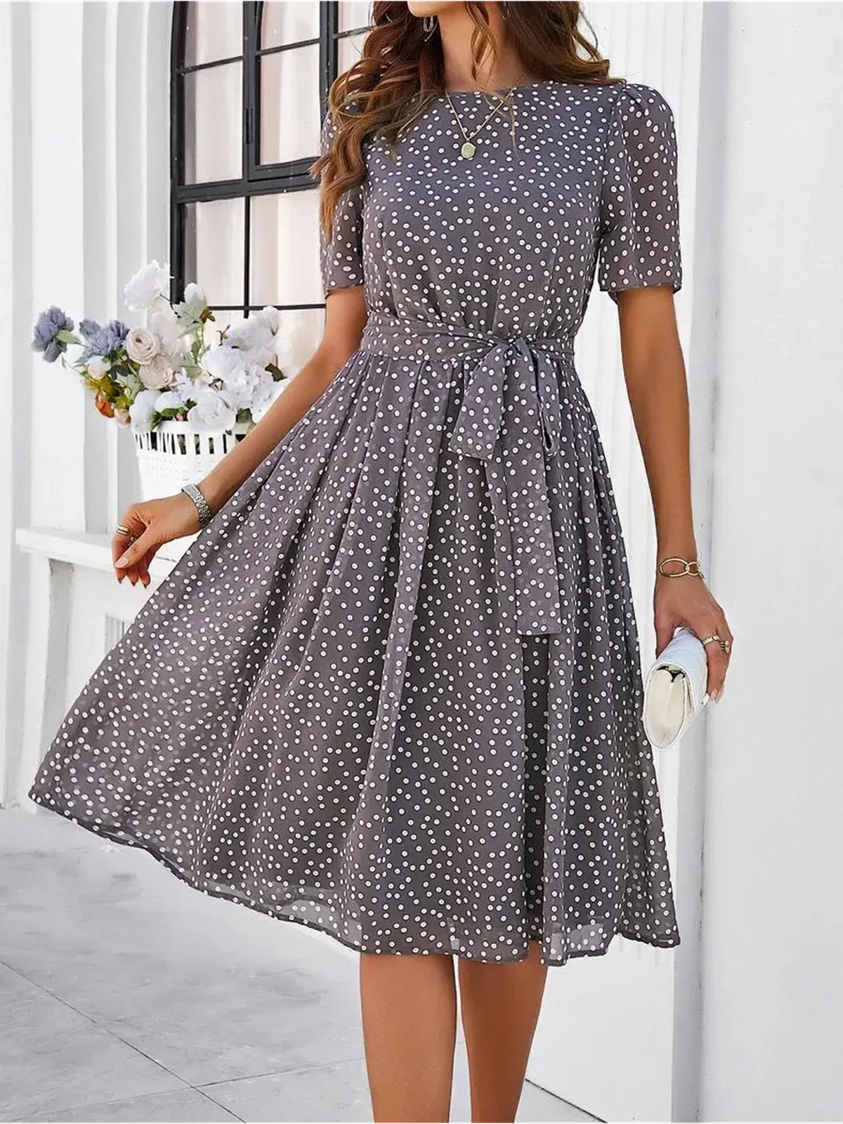 Serene Charm Midi Dress featuring a polka dot pattern, perfect for summer events or weddings, embodying modern elegance.