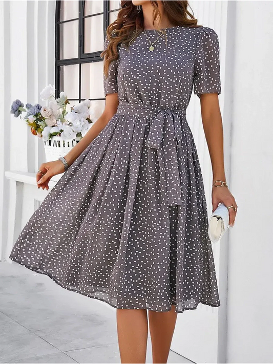 Serene Charm Midi Dress featuring a polka dot pattern, perfect for summer events or weddings, embodying modern elegance.