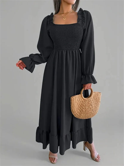 Elegant black Ruffle Grace Midi Dress with smocked bodice and long sleeves, perfect for weddings and casual occasions.