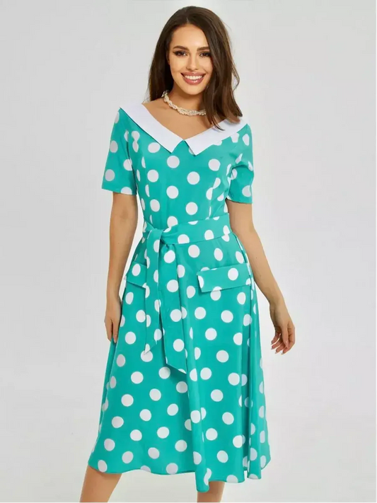Polka Grace Midi Dress featuring a vintage polka dot pattern, white collar, and tie waist for modern elegance.