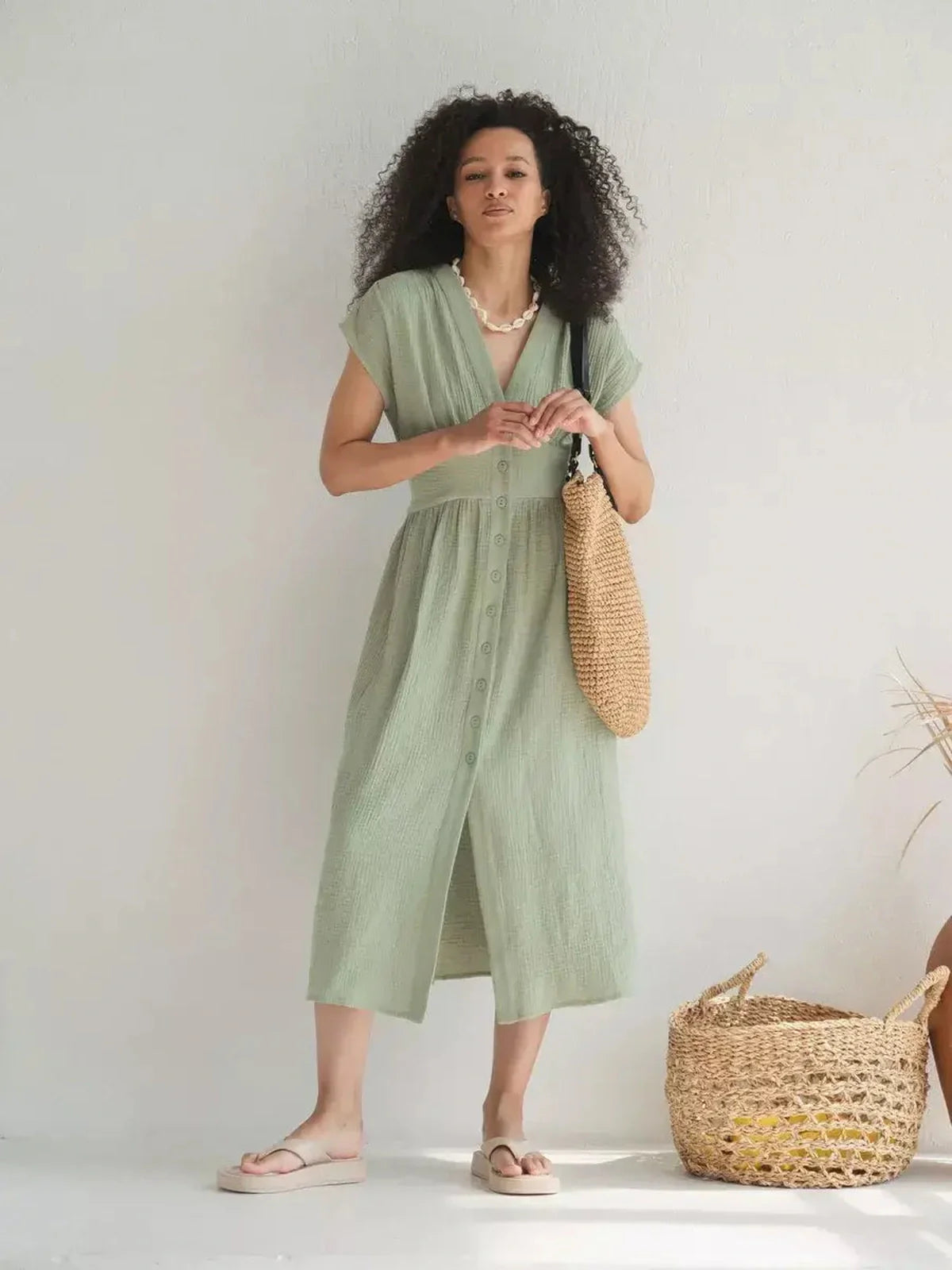Model wearing a lightweight khaki midi dress with V-neckline, perfect for summer and casual-chic occasions.