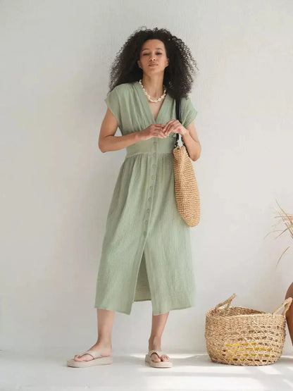 Model wearing a lightweight khaki midi dress with V-neckline, perfect for summer and casual-chic occasions.