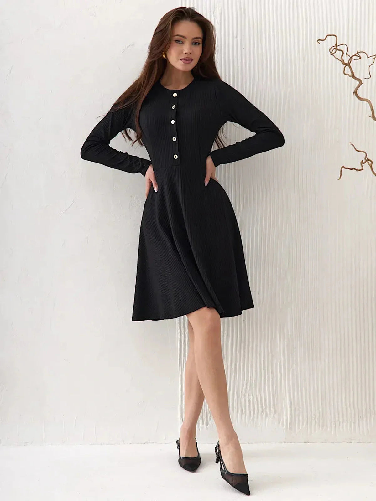 Effortlessly elegant Mod Noir black dress with long sleeves and button details, perfect for weddings and formal occasions.