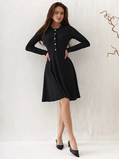 Effortlessly elegant Mod Noir black dress with long sleeves and button details, perfect for weddings and formal occasions.