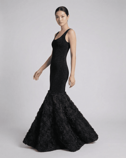 Sleek model showcasing the Slimona Nocturne Maxi Dress with textured hem detail in elegant black.