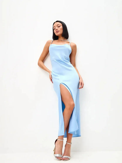 Icy Glow Midi Dress in light blue with thigh-high slit, cowl neckline, and crisscross straps, perfect for summer events.