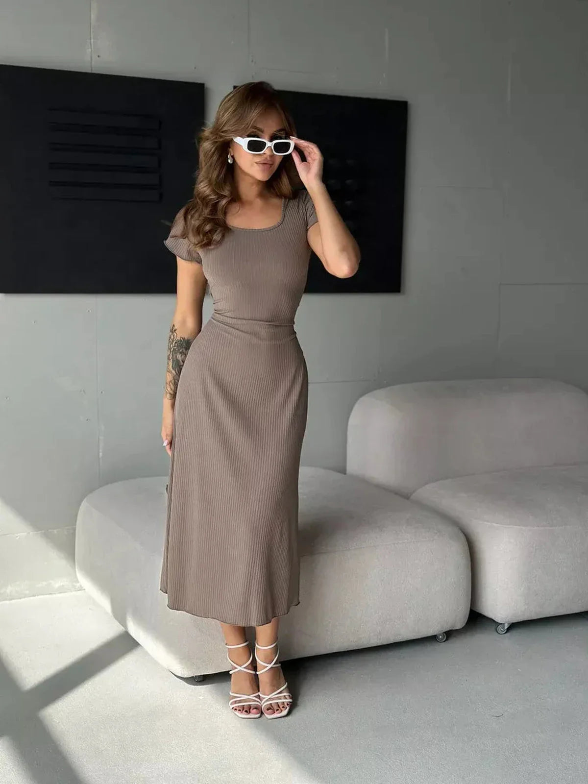 Stylish woman in a ribbed Contour Midi Dress, showcasing a sleek fit, perfect for weddings and formal occasions.