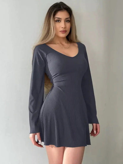 Noir Flare Midi Dress in deep black ribbed knit with long bell sleeves and scoop neckline, perfect for formal occasions.