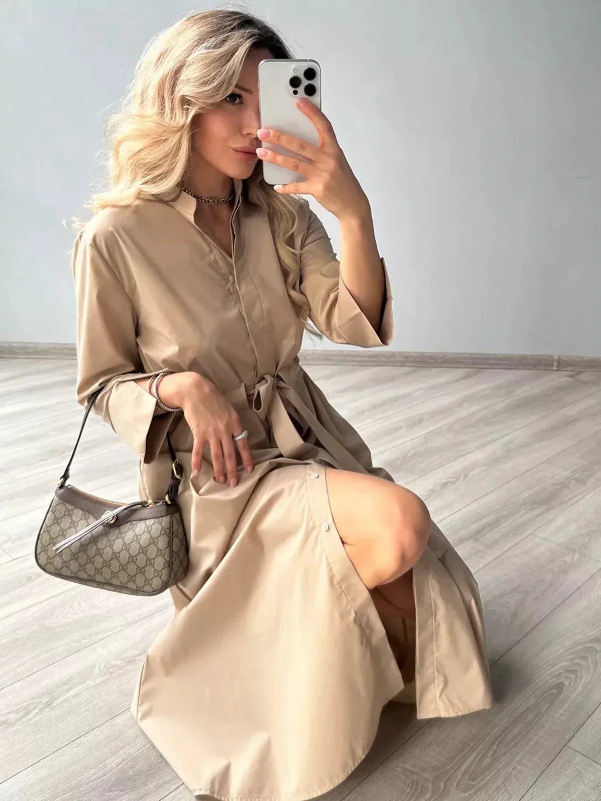 Model showcasing a Studio Beige Midi Dress with a belted waist, perfect for weddings and formal occasions.