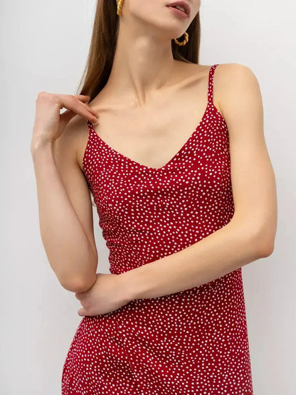 Model showcasing the Cherry Dots Midi Dress featuring a red hue and playful white polka dots, perfect for summer occasions.