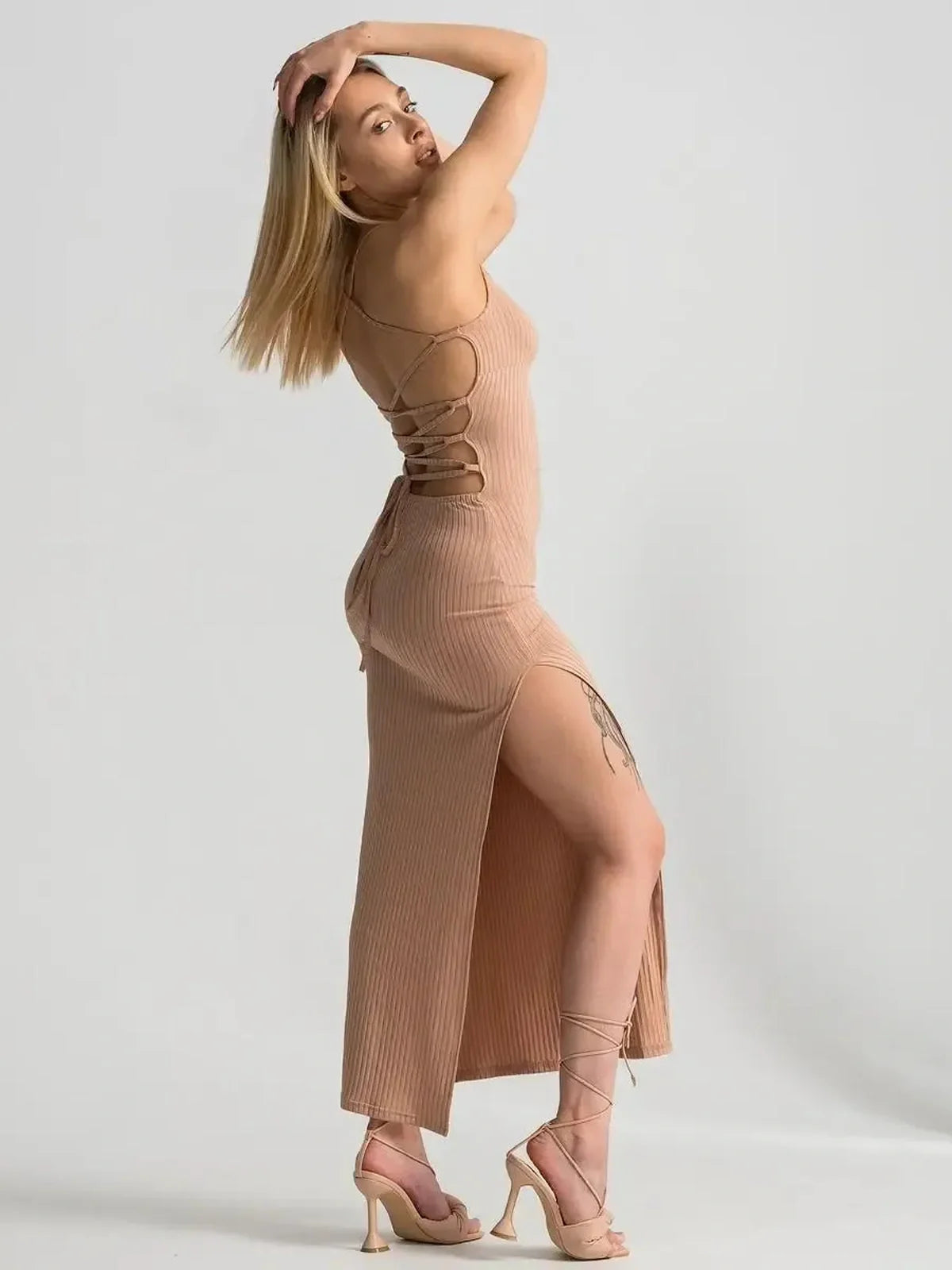 Nude lace midi dress featuring a ribbed fit, corset back, and thigh-high slit, ideal for summer evening events.