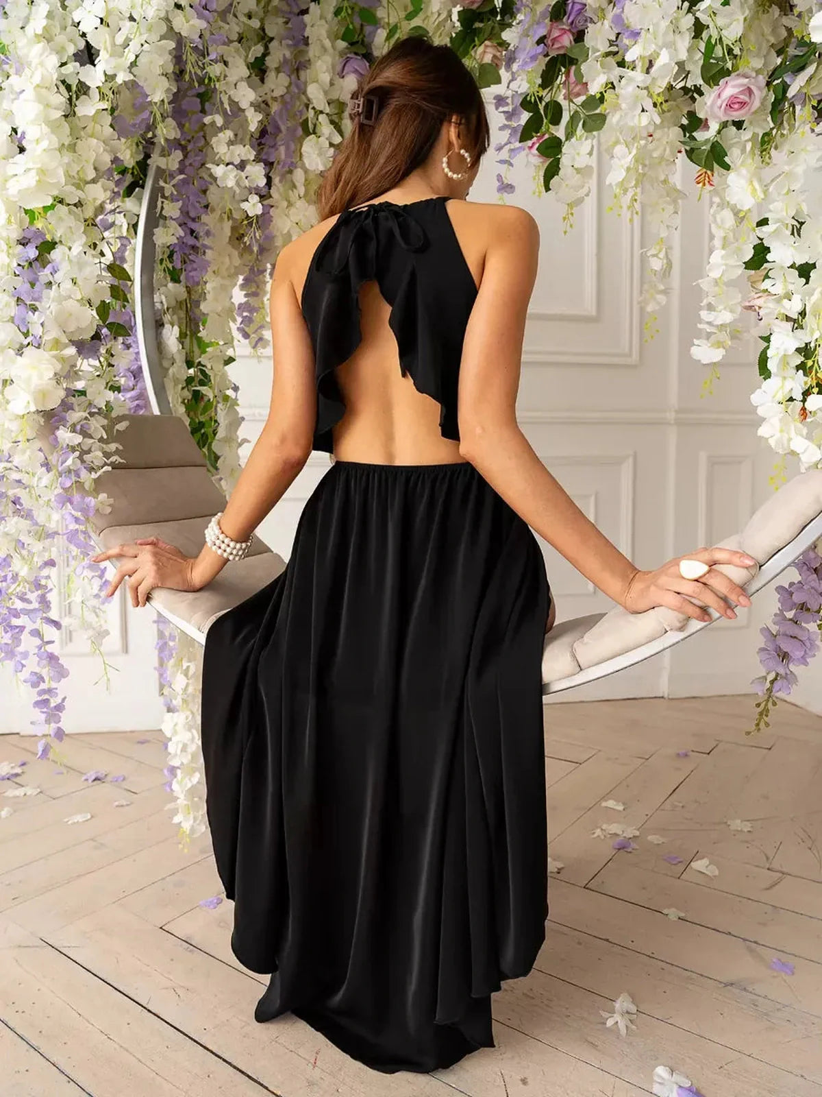 Elegant black Soirée Midi Dress with open back and flowing A-line silhouette, perfect for summer weddings and formal occasions.