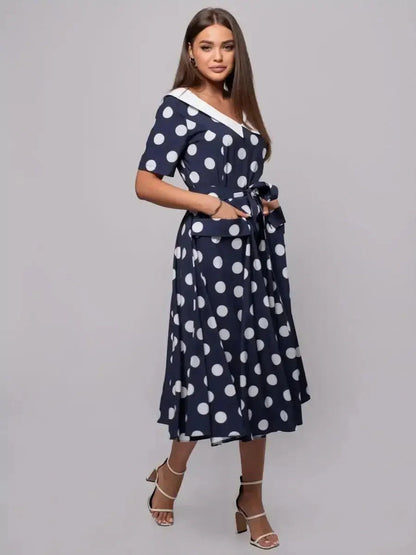 Nautical Charm Midi Dress features classic polka dots and a flattering fit-and-flare silhouette, perfect for summer events.