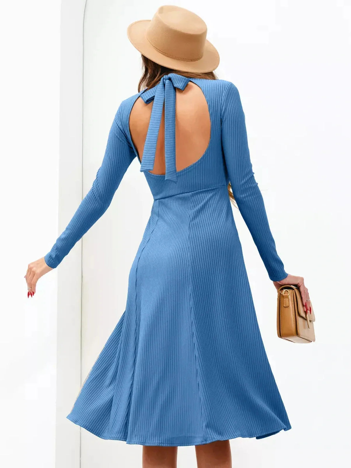Back view of a blue midi dress with open back and long sleeves, styled for summer celebrations.