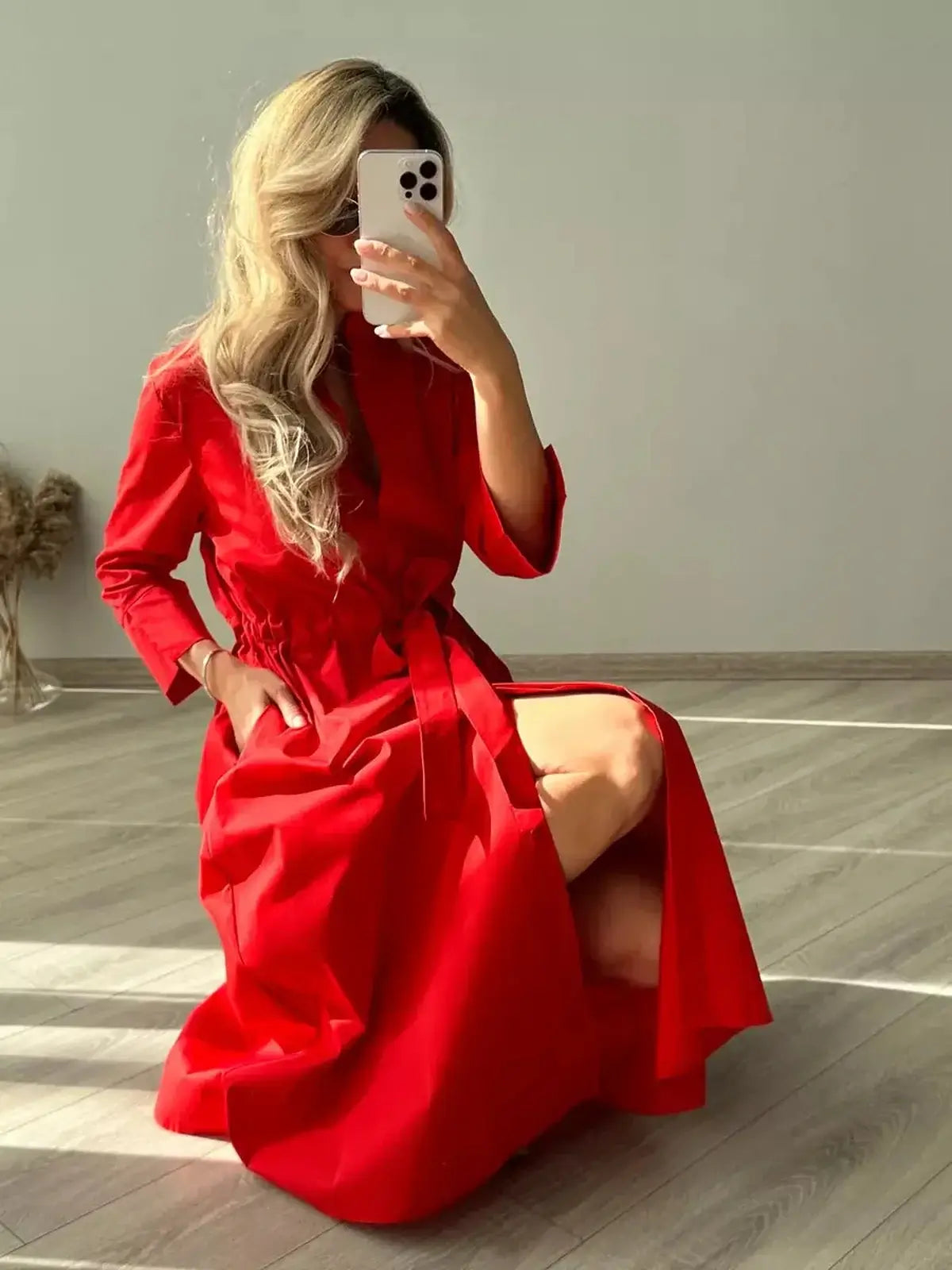 Model in a vibrant red midi dress, showcasing its effortless silhouette and tailored fit, ideal for special occasions.