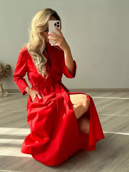 Model in a vibrant red midi dress, showcasing its effortless silhouette and tailored fit, ideal for special occasions.