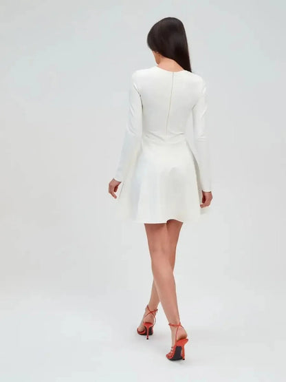 Back view of the Ivory Sculpt Dress, a minimalist white dress with long sleeves and a flared A-line skirt.