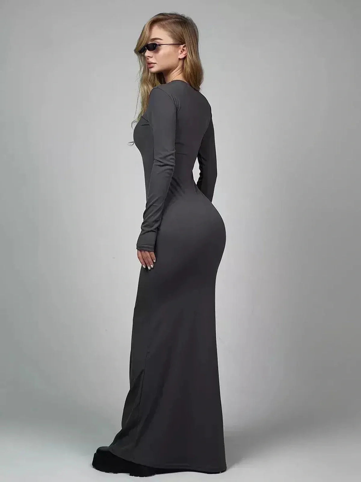 Sculpted Grace Maxi Dress in black, featuring a form-fitting silhouette and long sleeves, ideal for eveningwear.