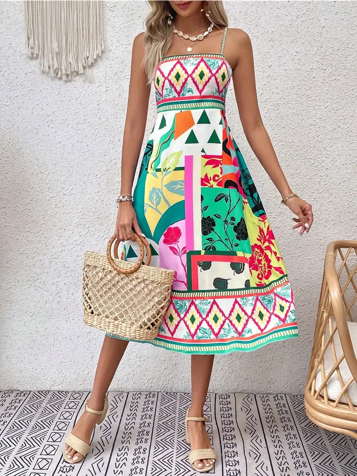 Model wearing the Tropica Muse Midi Dress with vibrant patterns, perfect for summer, weddings, or casual outings.