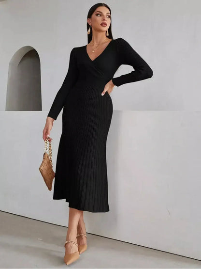 Sleek black midi dress with ribbed texture, long sleeves, and a high neckline, perfect for weddings and formal events.