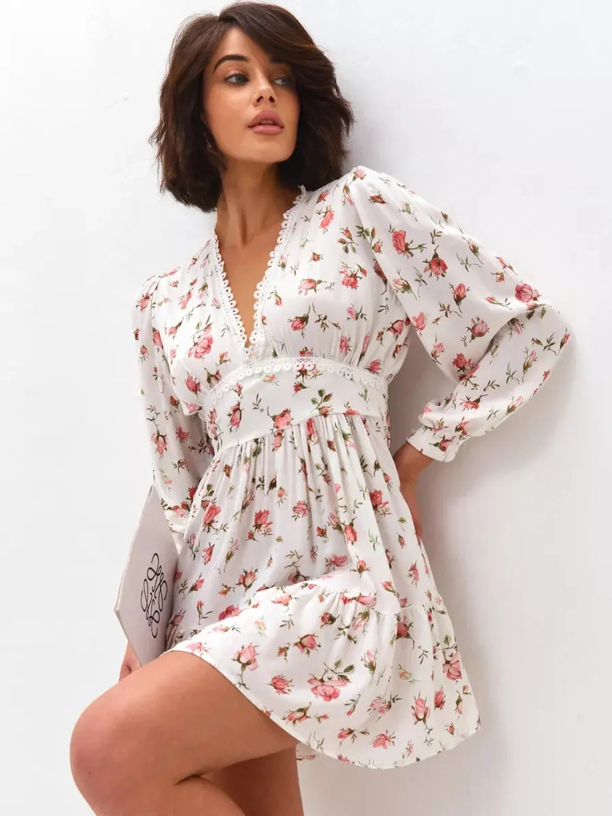 Model wearing the Rose Whimsy Mini Dress with floral details and lace trim, perfect for summer parties and weddings.