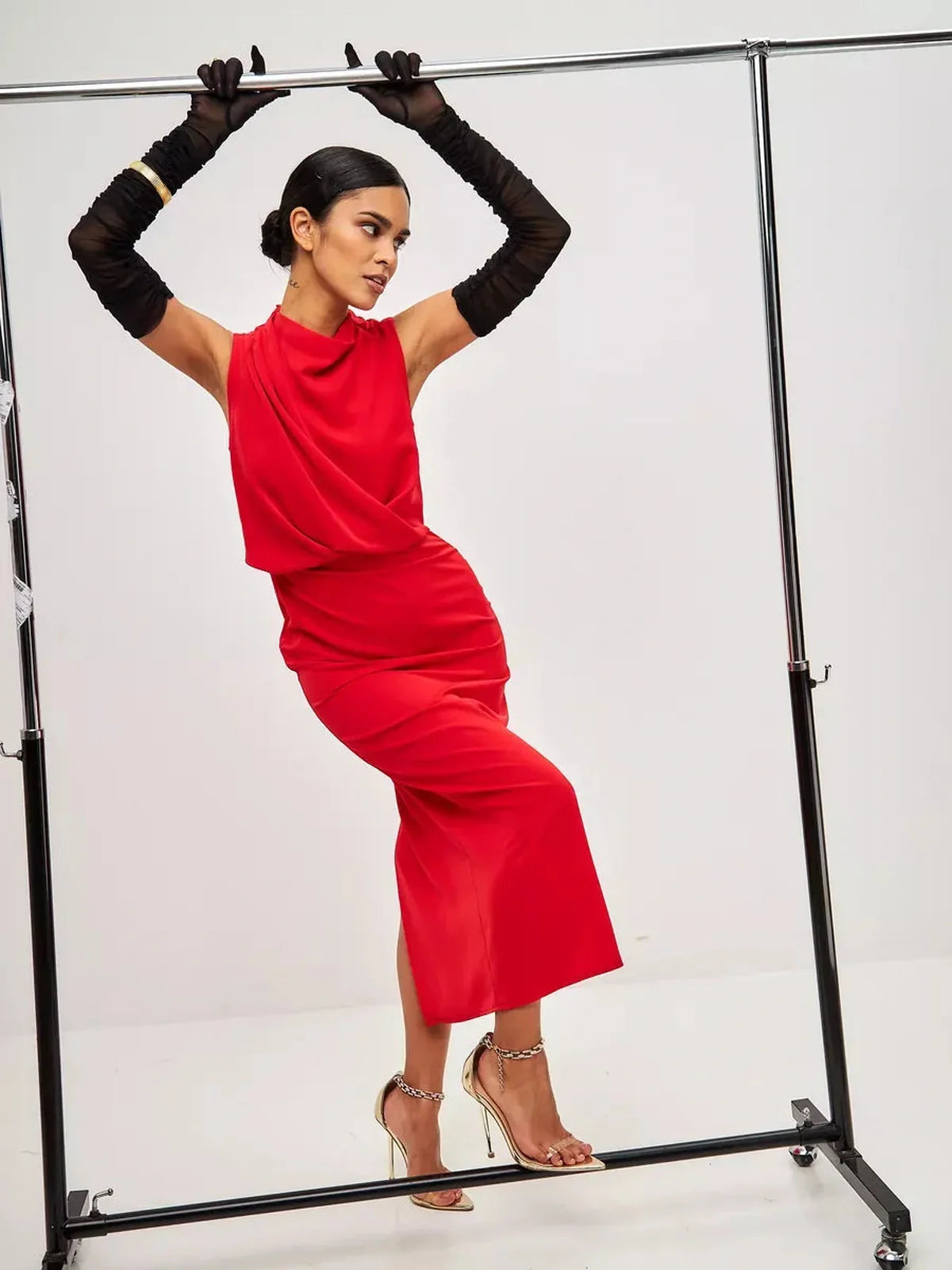 Model showcasing a stunning red drape maxi dress with fluid silhouette and elegant styling.