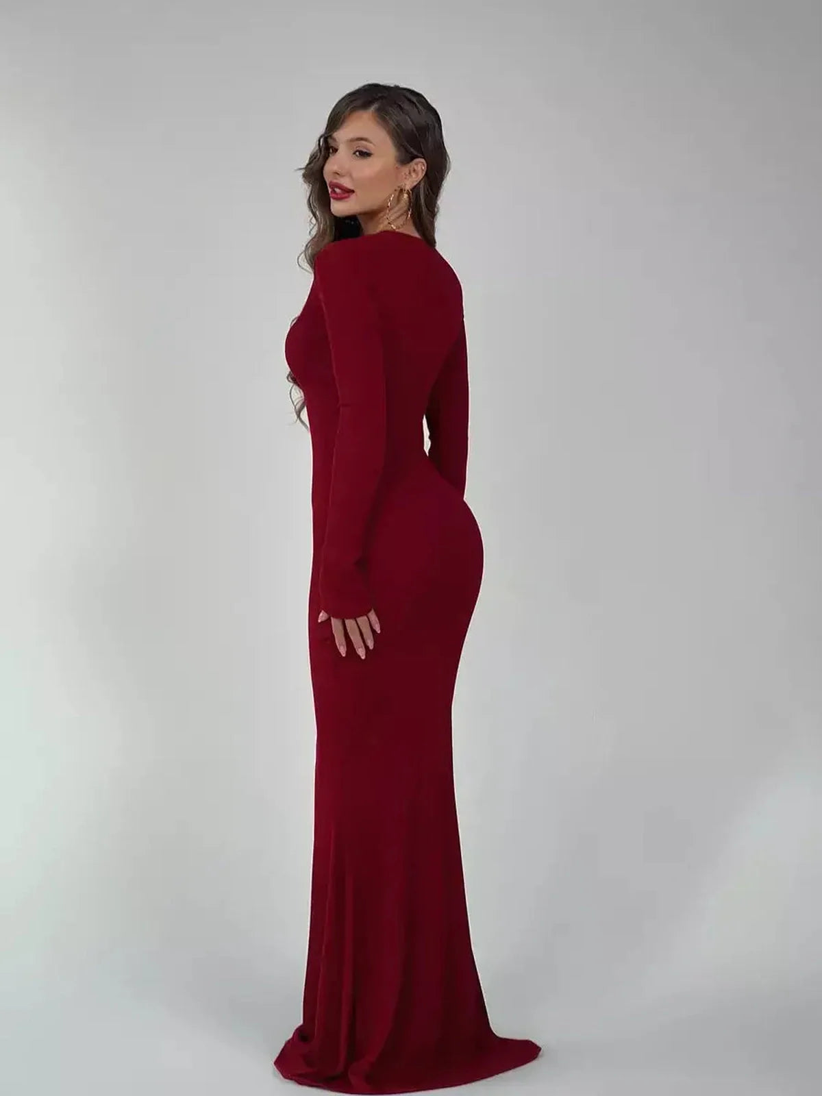 Elegant burgundy Velvet Ember Maxi Dress showcasing a sleek silhouette, perfect for weddings and formal events.