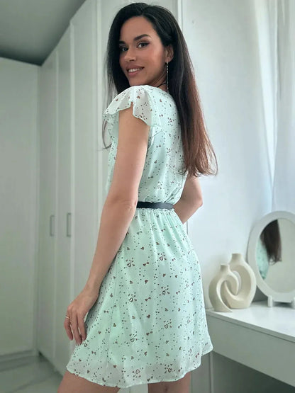 Model showcasing the Mint Glow Mini Dress, a flowy chiffon summer dress in a refreshing mint shade.