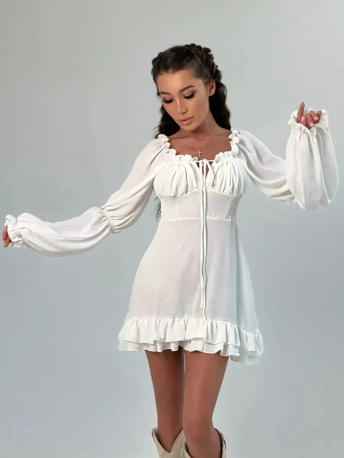 Ruffle Bloom Mini Dress in white featuring flowy sleeves and ruffles, perfect for summer or wedding guest occasions.