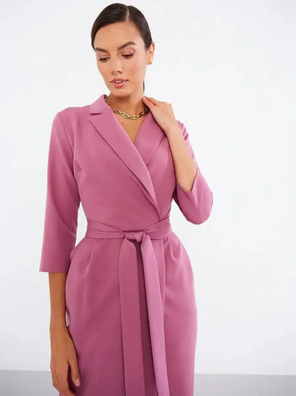 Blush Wrap Midi Dress featuring a belted waist, notched collar, and three-quarter sleeves for a sophisticated look.