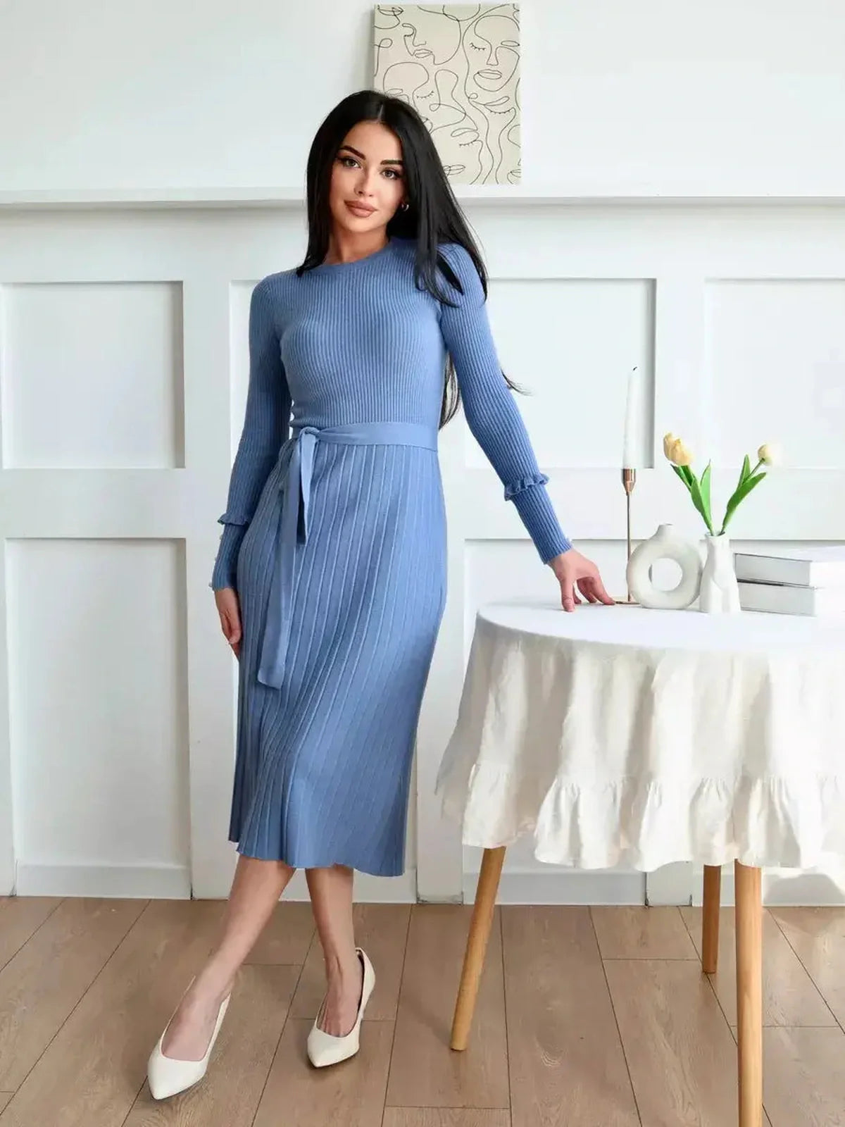 Model wearing a Serene Lines Midi Dress in blue with belt and pearl cuffs, ideal for weddings or cocktail events.