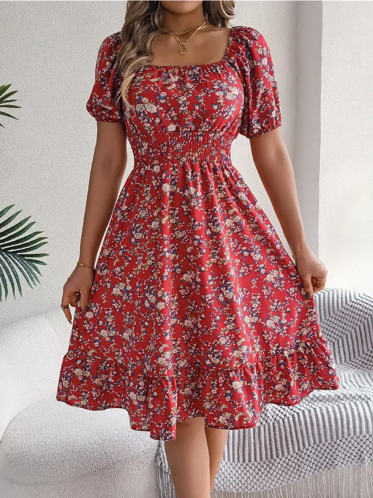 Red floral mini dress with puff sleeves and ruffled hem, perfect for summer weddings and casual outings.