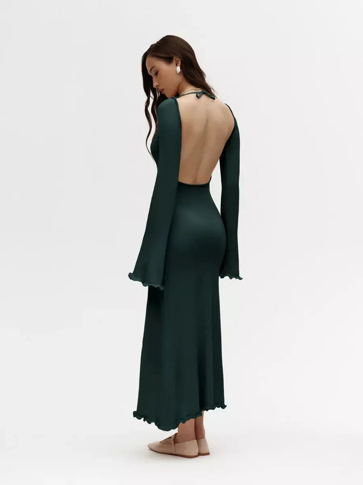 Model showcasing the back of the green Serenity Knit Midi Dress with flounced sleeves, perfect for formal and event wear.