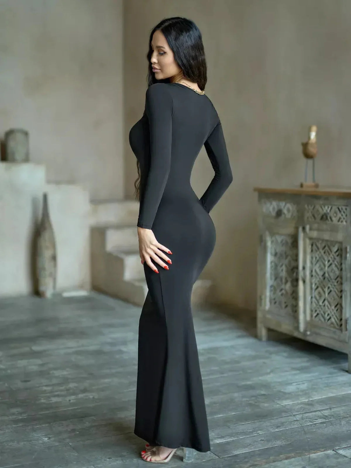 Sculpted Noir Maxi Dress in black, showcasing a sleek silhouette and long sleeves, perfect for formal occasions.