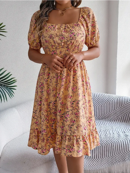 Marigold Bloom floral midi dress featuring puff sleeves, smocked waist, and ruffle hem for summer occasions.