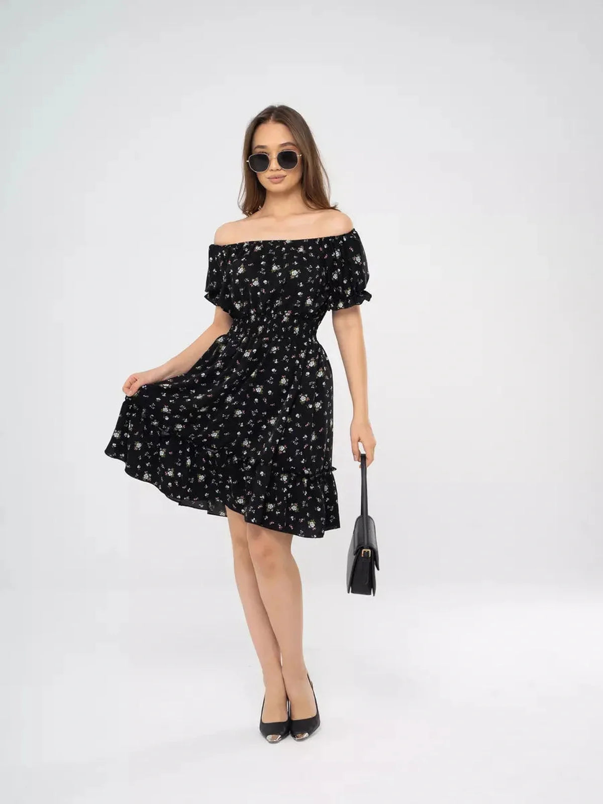 Elegant off-shoulder black dress with floral print, perfect for summer weddings and casual outings.