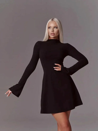 Model showcasing the Mod Muse black long sleeve mini dress with flared sleeves and high neck, perfect for formal occasions.