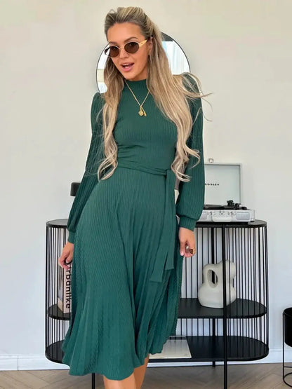 Emerald Poise Midi Dress featuring a ribbed texture and pleated A-line skirt, ideal for weddings and formal events.