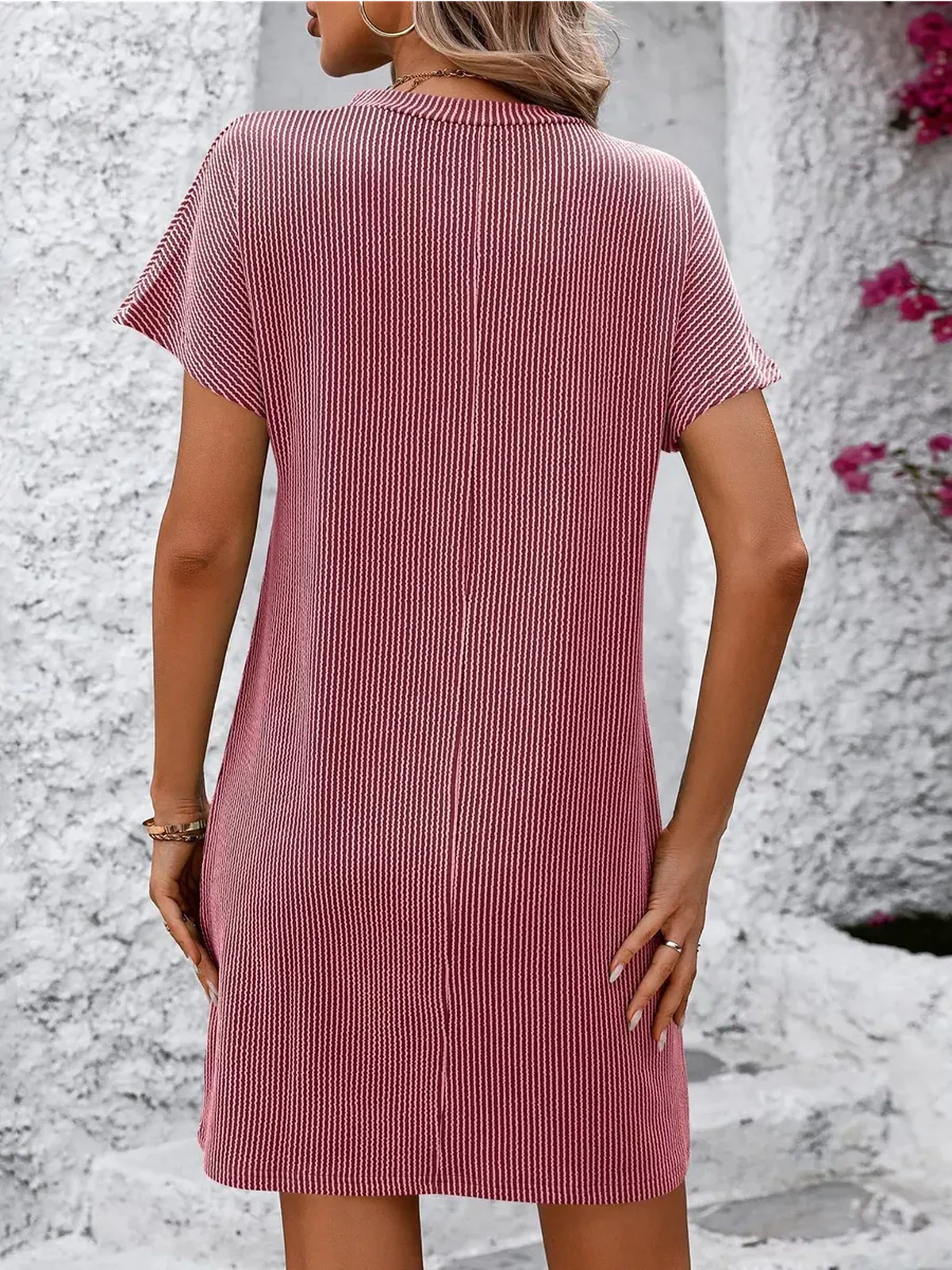 Back view of a ribbed pink mini dress, perfect for summer casual outings or as a versatile women's clothing option.