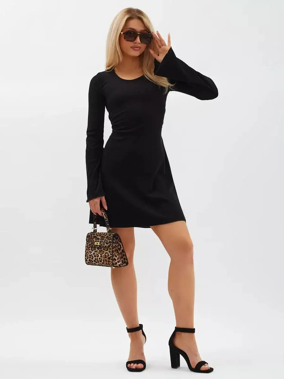 Noir Flare Mini Dress featuring long flared sleeves, a tie waist, and elegant black knit design, perfect for versatile styling.