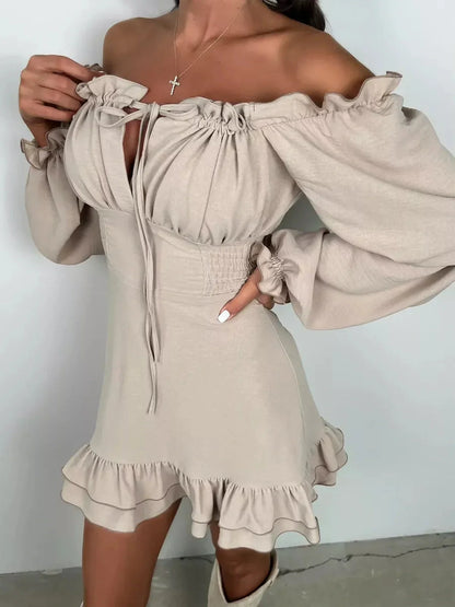 Beige off-shoulder Ruffle Muse Mini Dress with puff sleeves and flounced hemline, perfect for summer events.