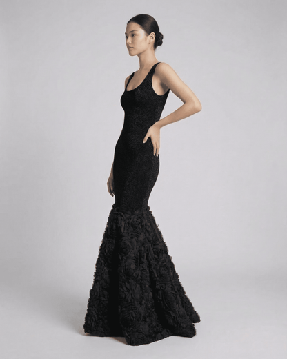 Nocturne Maxi Dress by Slimona, showcasing an elegant black sculpted silhouette with textured hem detail.