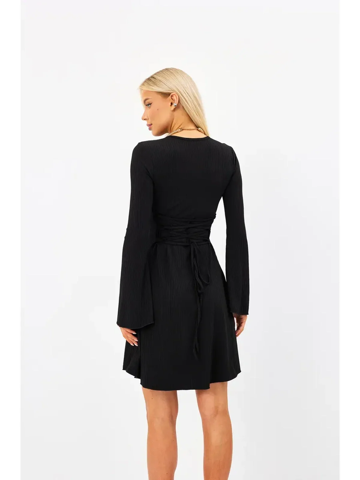 Back view of a Flare Charm Mini Dress, featuring a ribbed texture, fluted sleeves, and adjustable lace-up design.