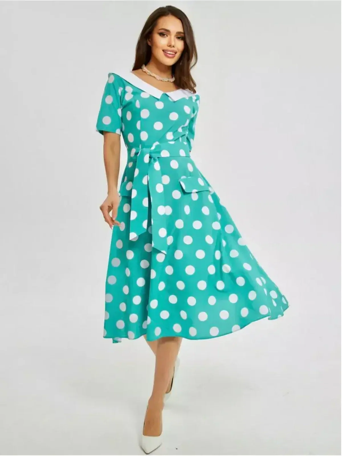 Polka Grace Midi Dress featuring a teal polka dot pattern, crisp white collar, and playful fit-and-flare silhouette.
