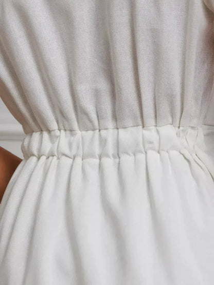 Detail of the cinched waist on the Maxi Dress Pearl Whisper, showcasing the elegant tie-front design.