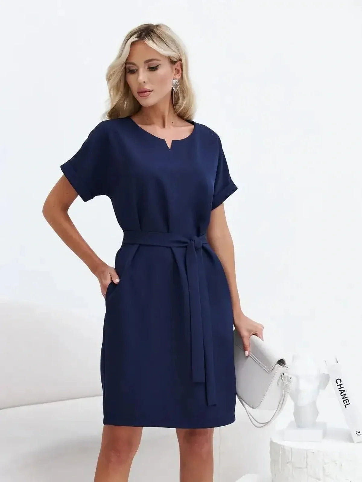Elegant navy mini dress with a structured silhouette and belt, perfect for weddings and formal occasions.